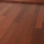Habitación con suelo de madera de Granadillo Rojo, paredes blancas, zócalos marrones, tomas de corriente y una pequeña estantería empotrada en una esquina.